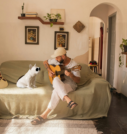User with Guitar and Bulldog Speaker